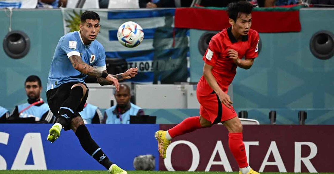 Uruguay's Mathias Olivera and South Korea's Kim Moon-hwan in action. Photo: AFP/Anne-Christine Poujoulat