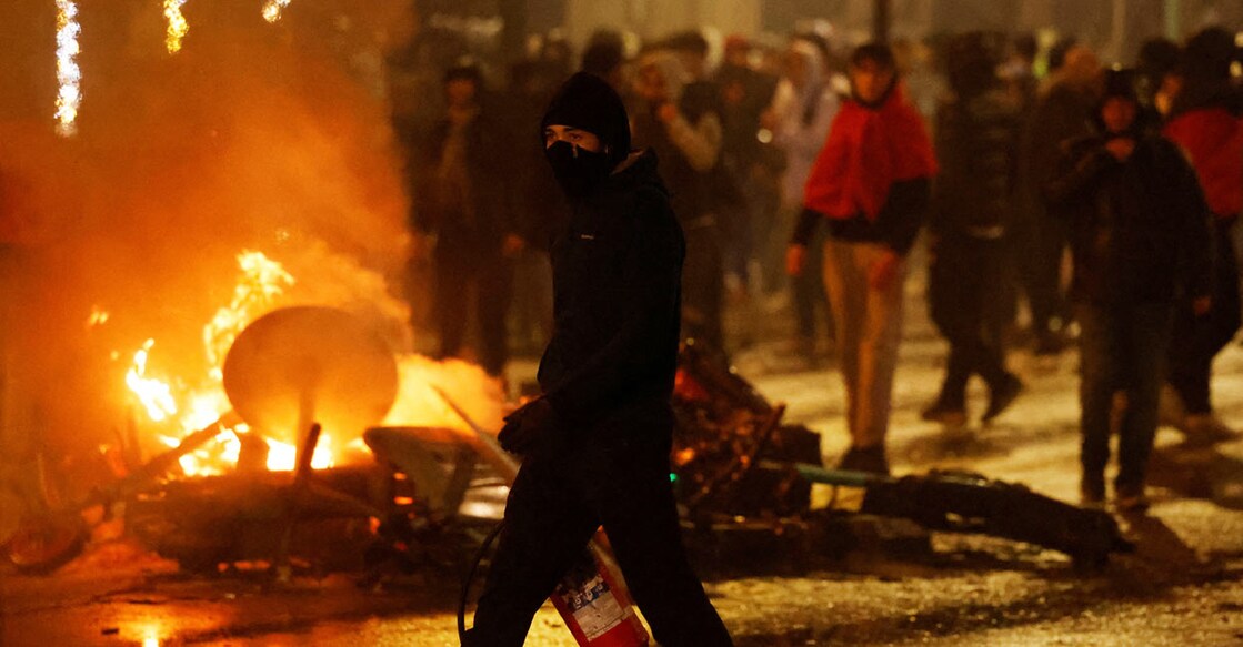 Dozens of rioters overturned and torched cars, set electric scooters on fire and pelted cars with bricks: Reuters