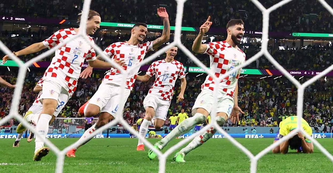 Croatia's Josko Gvardiol, Ante Budimir, Dejan Lovren, and Lovro Majer celebrate qualifying for the semifinals as Brazil's Marquinhos looks dejected after missing a penalty and being eliminated from the World Cup. Photo: Reuters/ Matthew Childs