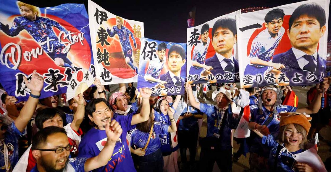 Japanese fans celebrate their win outside the Khalifa International Stadium in Doha. Phto: Reuters/Issei Kato