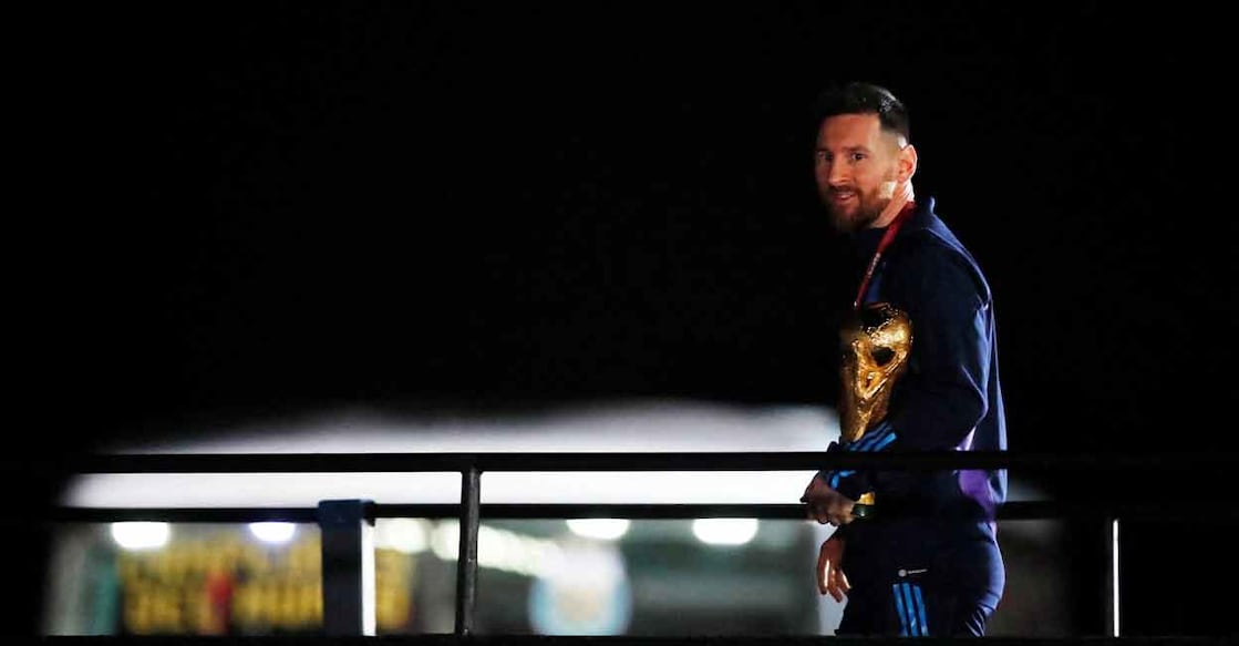 Lionel Messi with the World Cup trophy during the team's arrival at the Ezeiza International Airport. Photo: Reuters/Agustin Marcarian
