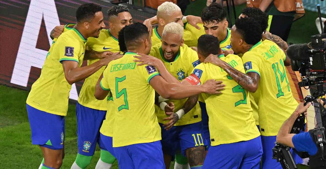 Brazil players celebrate their second goal. Photo: AFP/Glyn Kirk