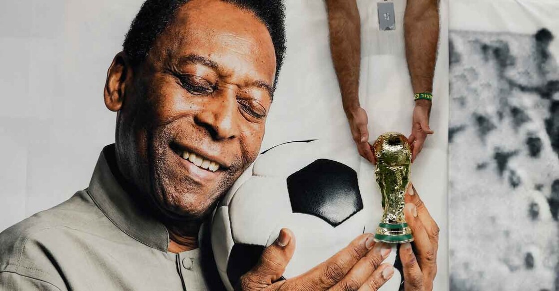 Brazil fan holds a replica World Cup trophy in front of a banner of Peleat the Lusail Stadium on December 2, 2022. File photo: Reuters/Benoit Tessier