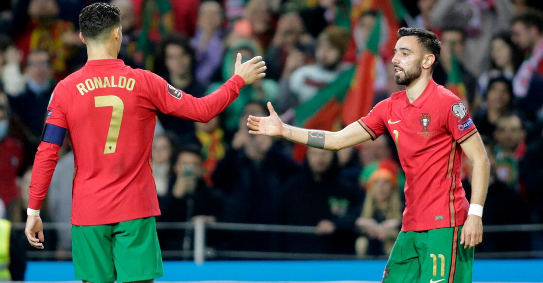 Portugal's Cristiano Ronaldo congratulates Bruno Fernandes on scoring their second goal . Photo: Reuters/Miguel Vidal
