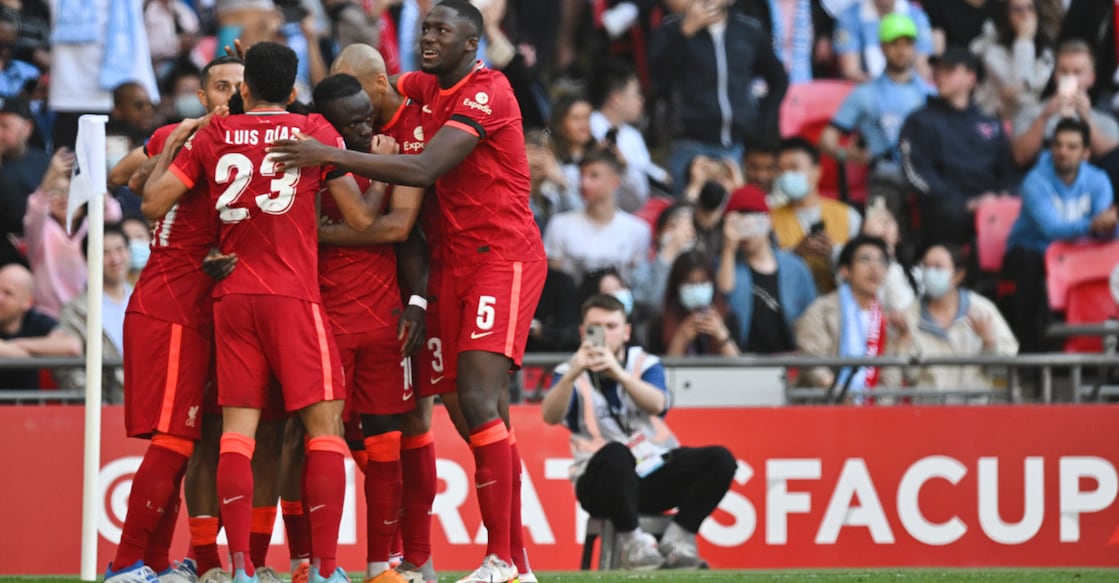 Liverpool players celebrate their third goal. Photo: AFP/Glyn Kirk