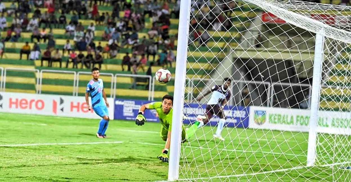 Services goalkeeper Bhabindra Malla Thakuri watches as a shot from Karnataka striker Ankith P curls toward goal in the Santosh Trophy at the Payyanad Stadium in Malappuram on Thursday. Photo: Special arrangement