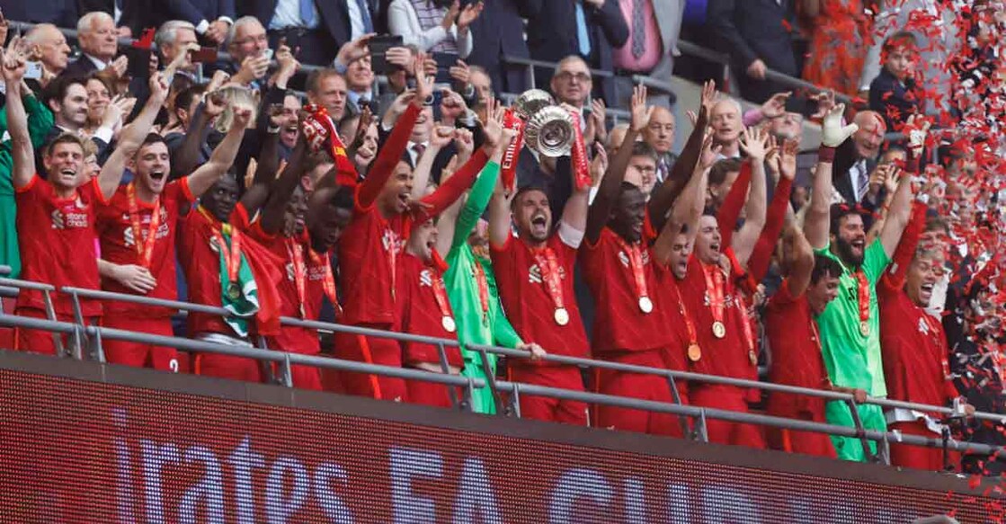 Liverpool's Jordan Henderson lifts the FA Cup with teammates. Photo: Reuters/Peter Cziborra
