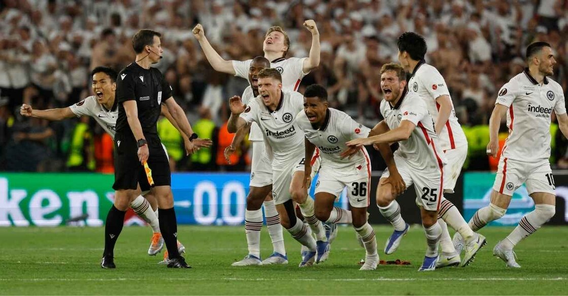Eintracht Frankfurt's Ansgar Knauff, Christopher Lenz and teammates celebrate winning the Europa League after Rafael Santos Borre scored the winning penalty during the shoot-out REUTERS/Susana Vera