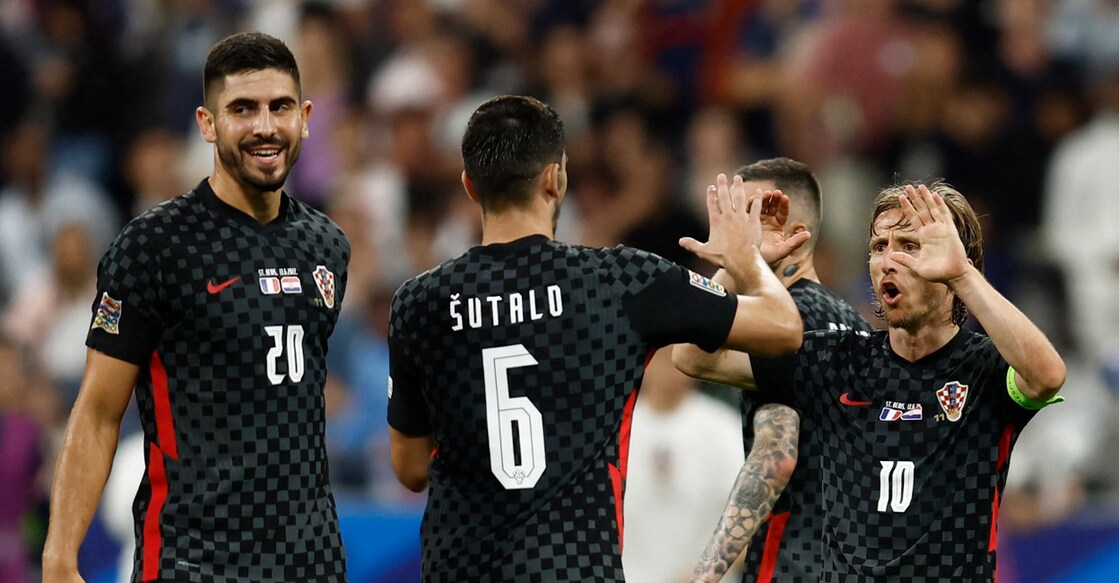 Croatian captain Luka Modric, right, celebrates with teammates after the match. Photo: Reuters/Gonzalo Fuentes