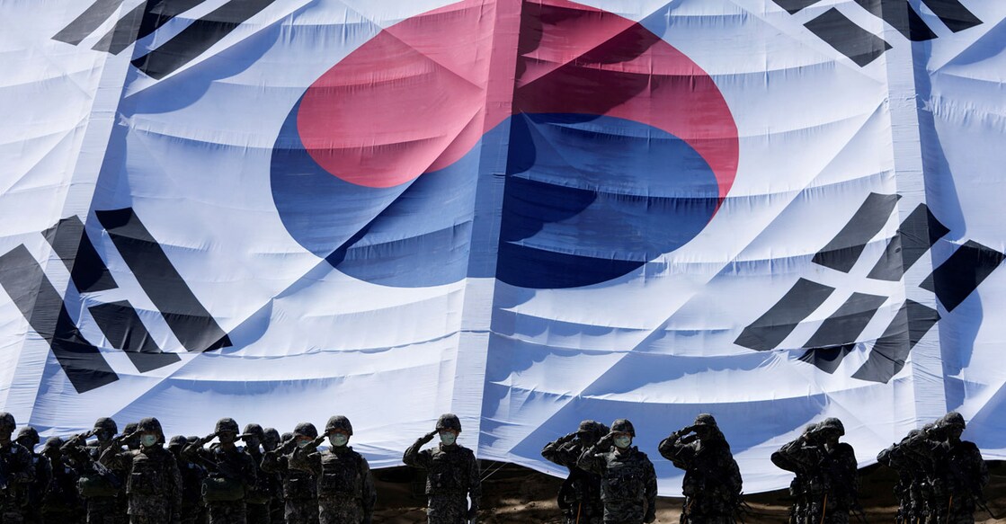 South Korean soldiers salute in front of a huge national flag in Pohang on September 30, 2021. File photo: Reuters/Lee Jin-Man