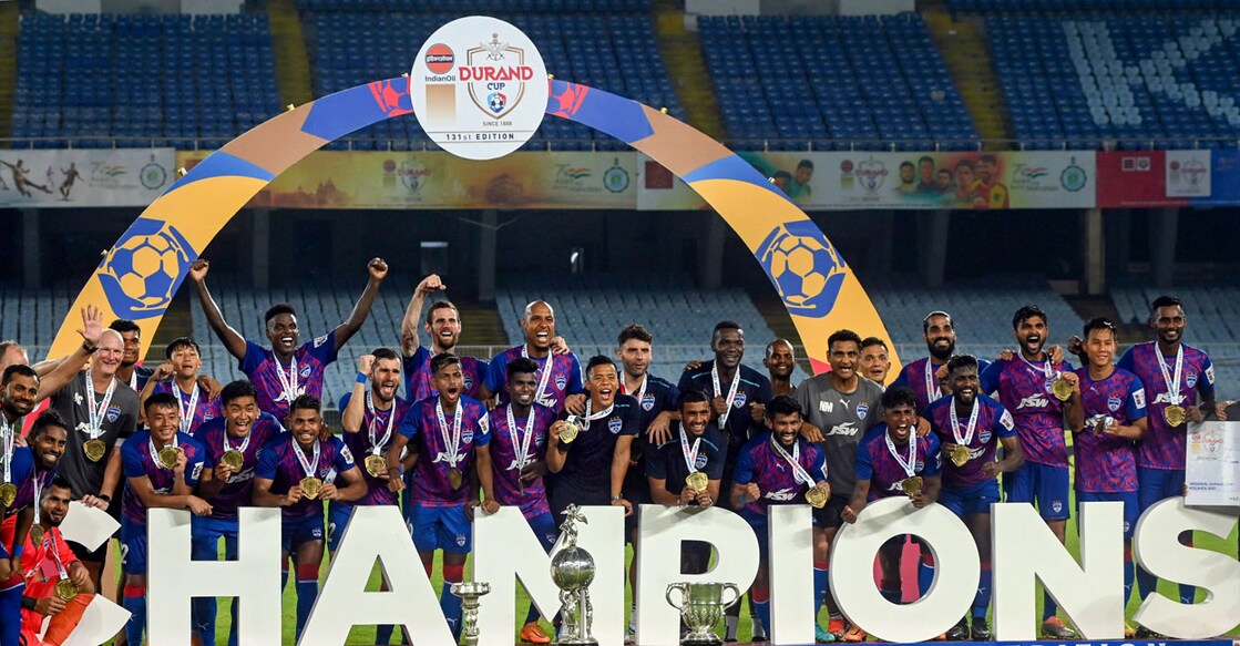 Bengaluru FC players pose with the Durand Cup trophy after defeating Mumbai City in Kolkata on Sunday. Photo: PTI 