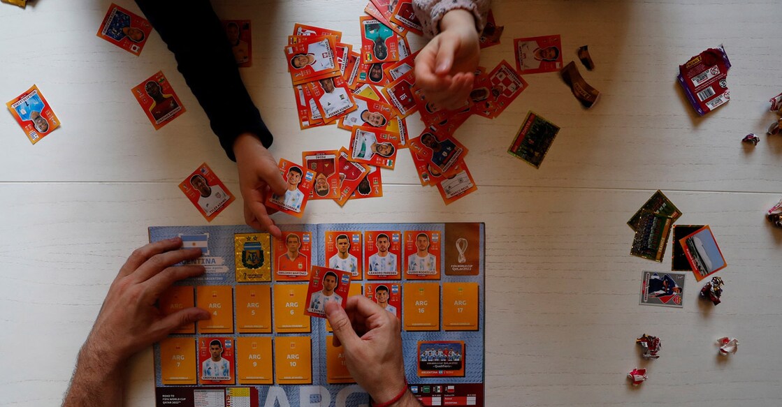 Lucas Perrone pastes World Cup stickers with his kids in Buenos Aires. File photo: Reuters/Agustin Marcarian