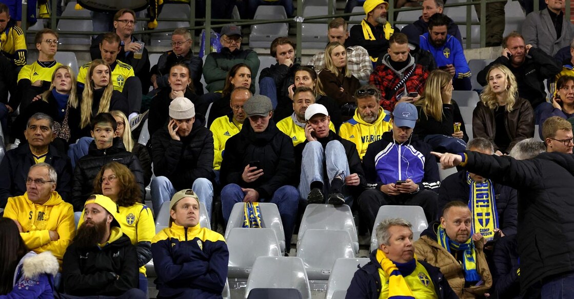 Swedish fans inside the stadium as play is suspended in Brussels. Photo: Reuters/Yves Herman