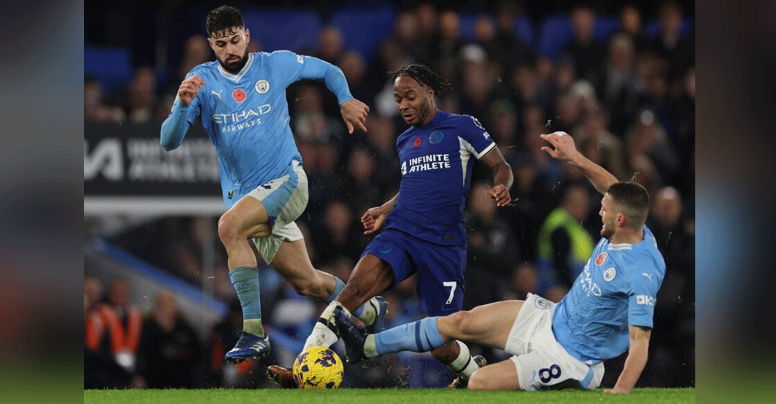 Manchester City's Croatian midfielder Mateo Kovacic tackles Chelsea's English midfielder Raheem Sterling during the English Premier League match at Stamford Bridge in London on Sunday. Photo: AFP/ Adrian Dennis