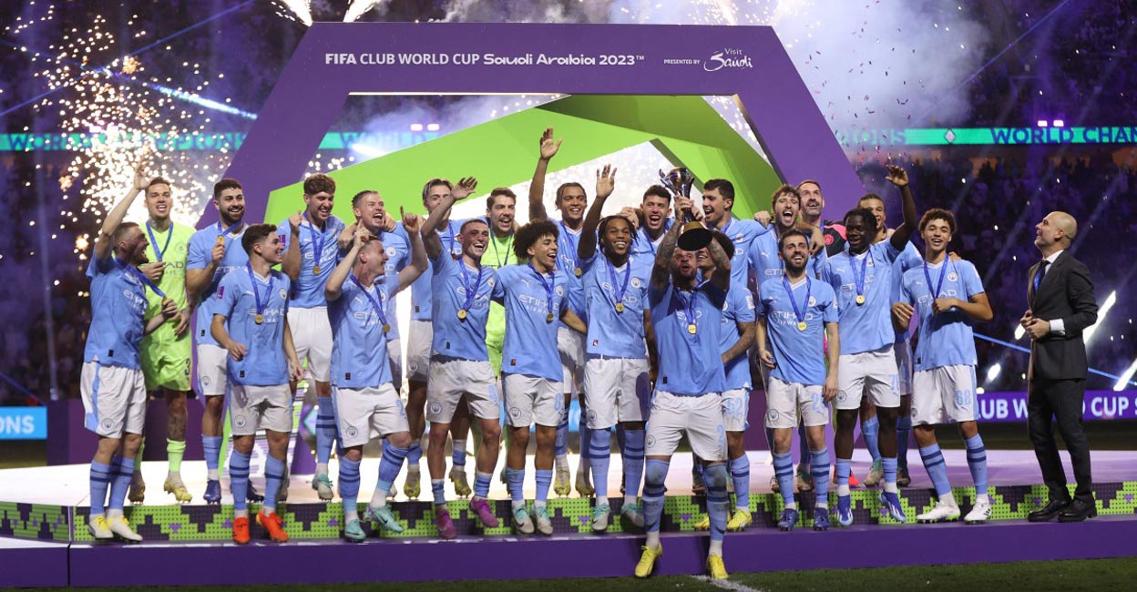 Manchester City captain Kyle Walker lifts the trophy as his teammates celebrate. Photo: AFP