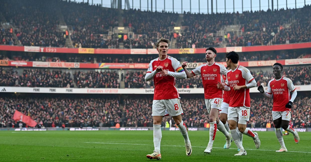 Arsenal Arsenal's Martin Odegaard, left,,celebrates scoring their second goal against Wolverhampton Wanderers. Photo: AFP/Glyn Kirk
