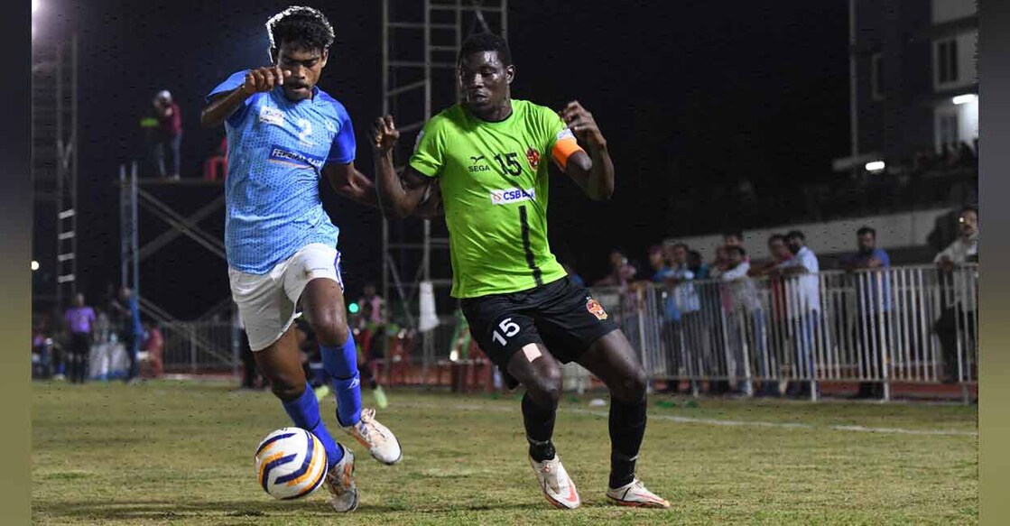 Gokulam Kerala's captain Samuel Mensah (green) vies for the ball with Kovalam FC defender Ranjith A during the first leg of the Kerala Premier League semifinal in Wayanad on Tuesday. Photo: Special arrangement