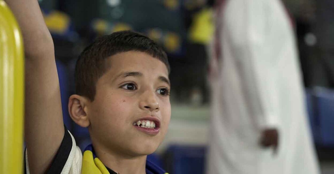 Syrian boy Nabil Saeed cheers for Al Nasr during the match against Al Batin in Riyadh on Friday. Photo: Reuters/Mohammed Benmansour