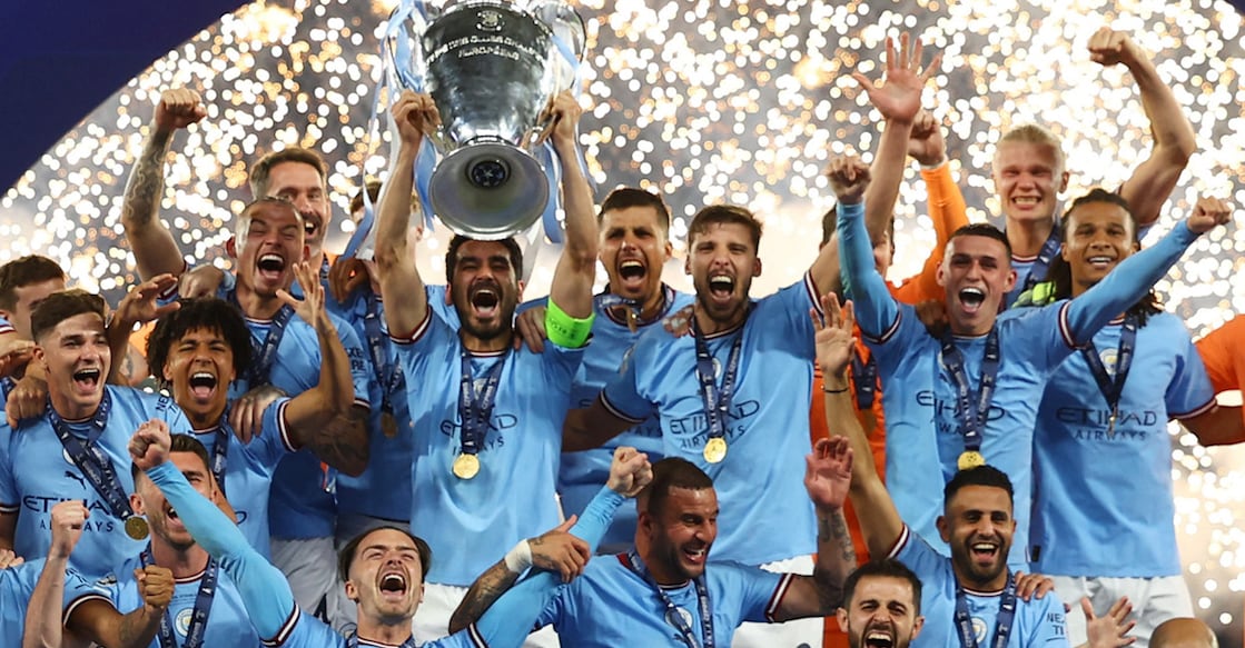 Manchester City's Ilkay Gundogan lifts the trophy as he celebrates with teammates after winning the Champions League. Photo: REUTERS/Molly Darlington
