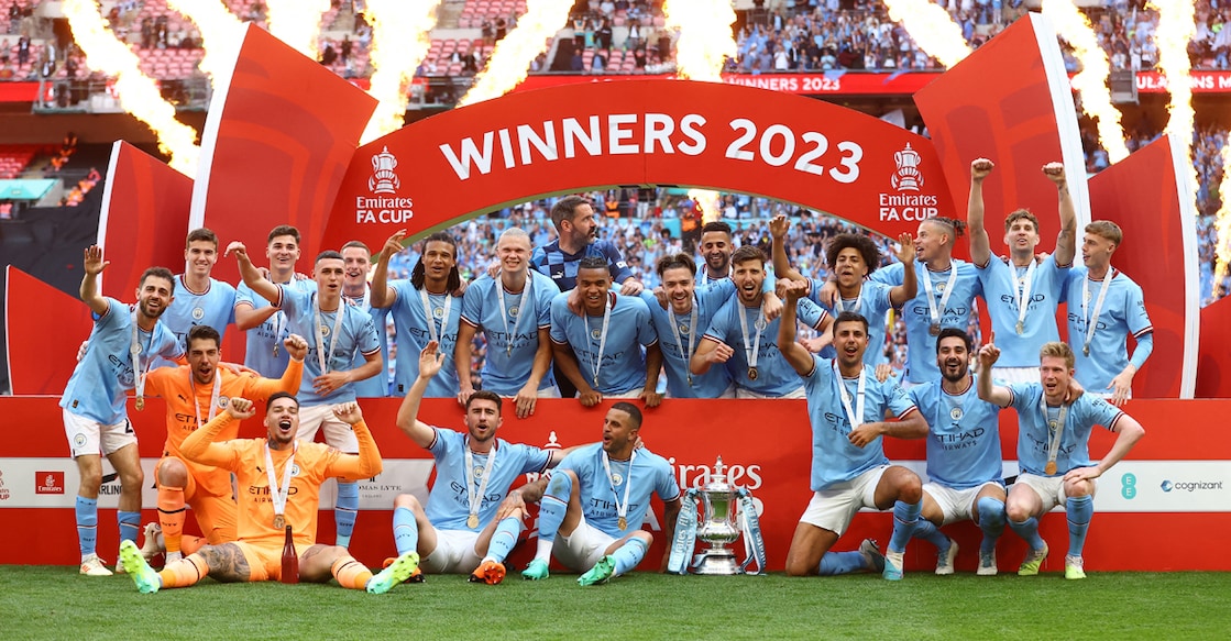 Manchester City players celebrate with the trophy after winning the FA Cup. Photo: Reuters/Carl Recine