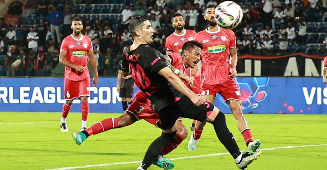 Action between NorthEast United (red) and Mumbai City FC. Photo: ISL