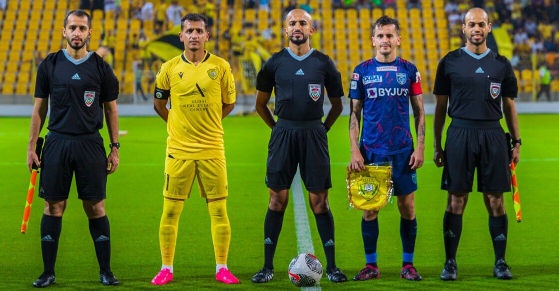 Kerala Blasters' captain Adrian Luna (blue) poses for a photograph with Al Wasl skipper Omar Abdul Rahman and the match officials before the friendly at Zabeel Stadium in Dubai. Photo: X/@AlWaslSC