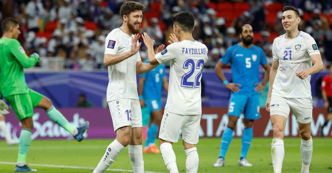 Uzbekistan's Sherzod Nasrullaev (13) celebrates with teammates after scoring his team's third goal against India during the Qatar 2023 AFC Asian Cup Group B match at the Ahmad bin Ali Stadium in Al-Rayyan, west of Doha on Thursday. Photo: AFP/ Karim Jaafar