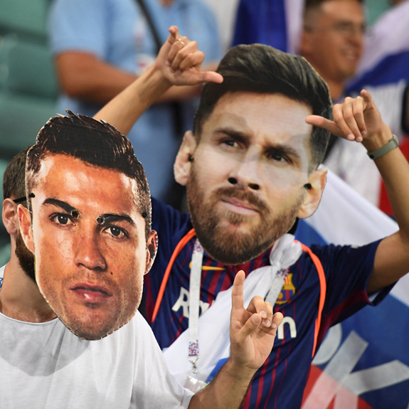 FBL-WC-2018-MATCH59-RUS-CRO-FANS Football fans wearing masks depicting Portugal's forward Cristiano Ronaldo and Argentina's forward Lionel Messi pose before the Russia 2018 World Cup quarterfinal match between Russia and Croatia at the Fisht Stadium in Sochi on July 7, 2018. File photo: AFP/ Kirill Kudryavtsev