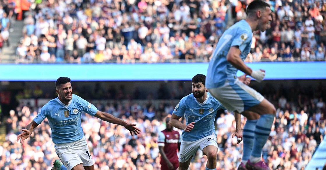 Manchester City's Rodri, left, celebrates scoring their third goal. Photo: AFP/Oli Scarff