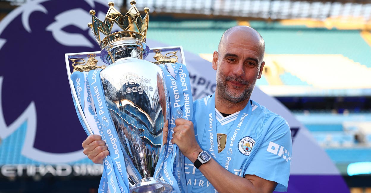 Pep Guardiola Manchester City manager Pep Guardiola celebrates with the trophy after winning the Premier League. Photo: Reuters/Molly Darlington