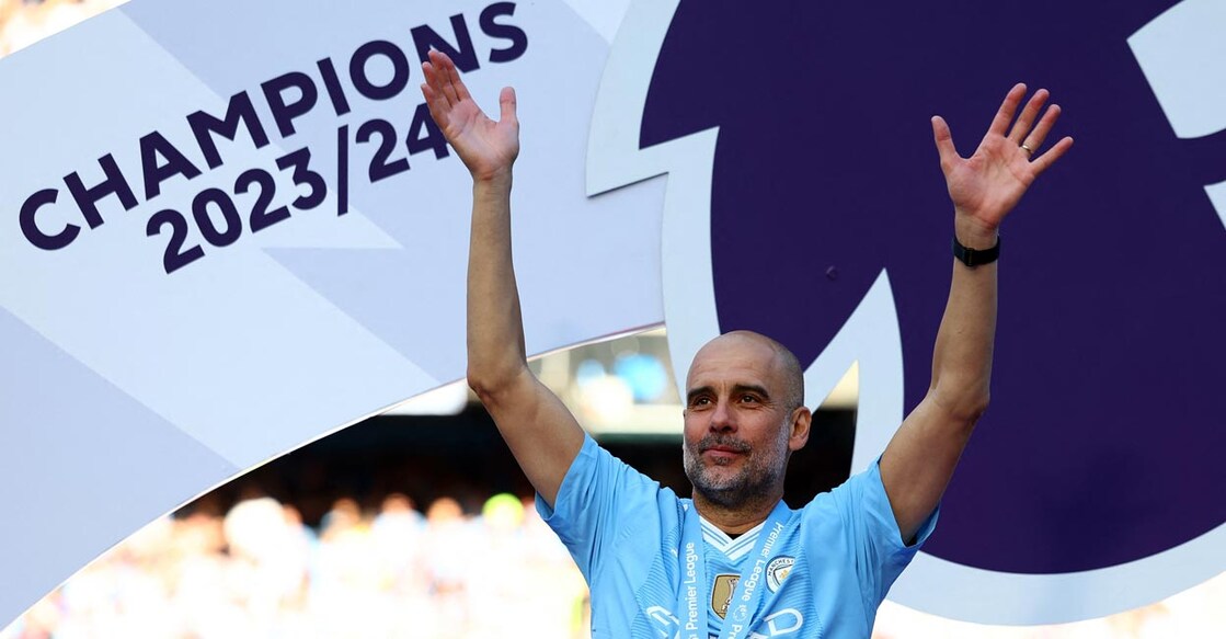 Manchester City manager Pep Guardiola celebrates after winning the Premier League. Photo: Reuters/Molly Darlington