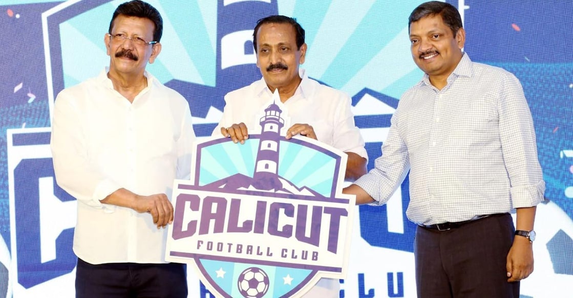 V K Mathews releases the logo in the presence of Kozhikode MP M K Raghavan and KFA president Navas Meeran. Photo: IANS