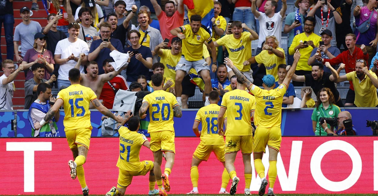 Romania's Razvan Marin celebrates scoring their second goal with teammates and fans. Photo: Reuters. 