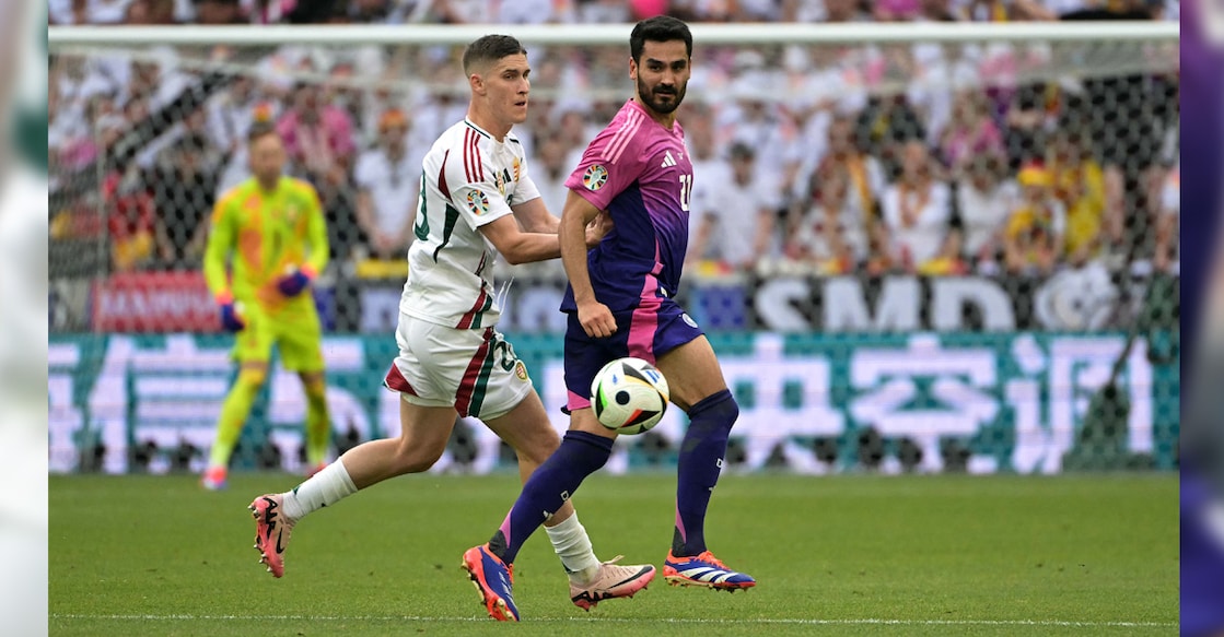 Hungary's forward Roland Sallai (left) fights for the ball with Germany's midfielder Ilkay Gundogan during the UEFA Euro 2024 Group A football match at the Stuttgart Arena in Stuttgart on June 19, 2024. Photo: AFP/ Damien Meyer