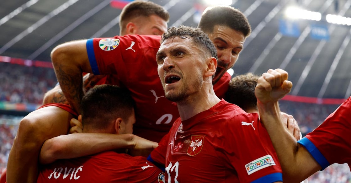 Serbian players celebrate scoring the equaliser. Photo: Reuters/Michaela Stache