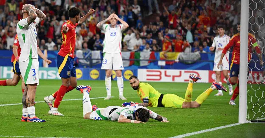 Italy's Riccardo Calafiori looks dejected after he scores Spain's first with an own goal Photo: REUTERS/Carmen Jaspersen