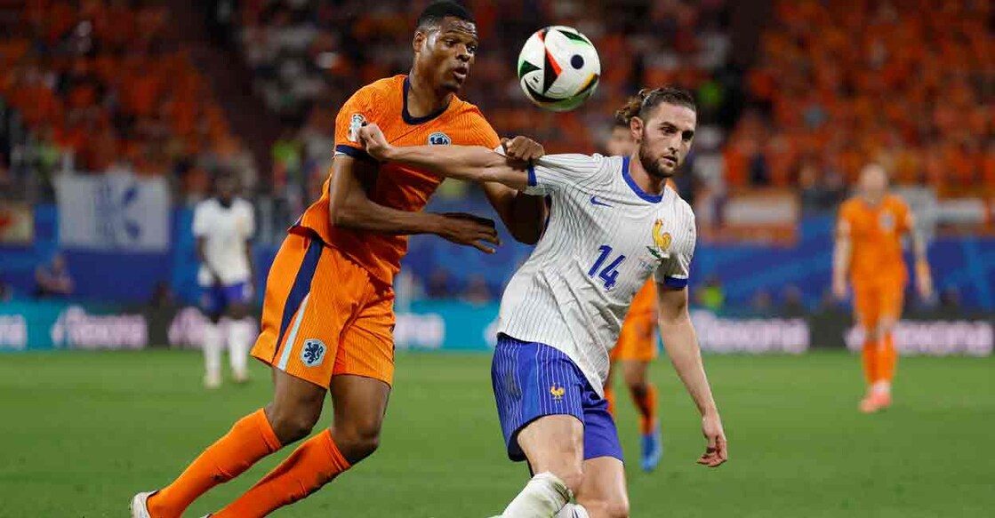 Netherlands' Denzel Dumfries in action with France's Adrien Rabiot. Photo: REUTERS/John Sibley