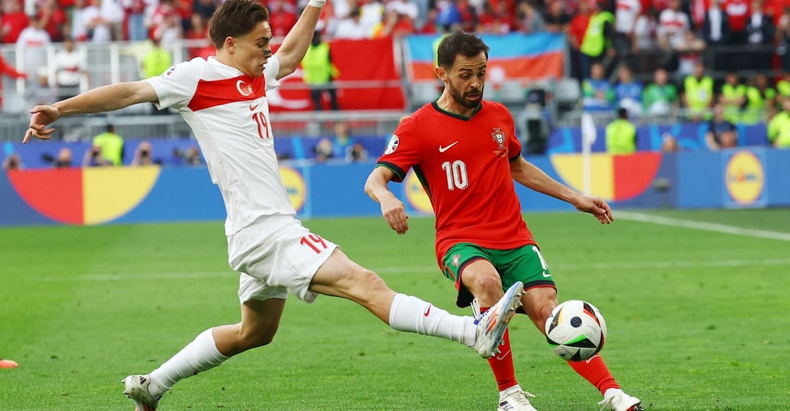 Turkey's Kenan Yildiz and Portugal's Bernardo Silva fight for possession. Photo: Reuters/Bernadett Szabo