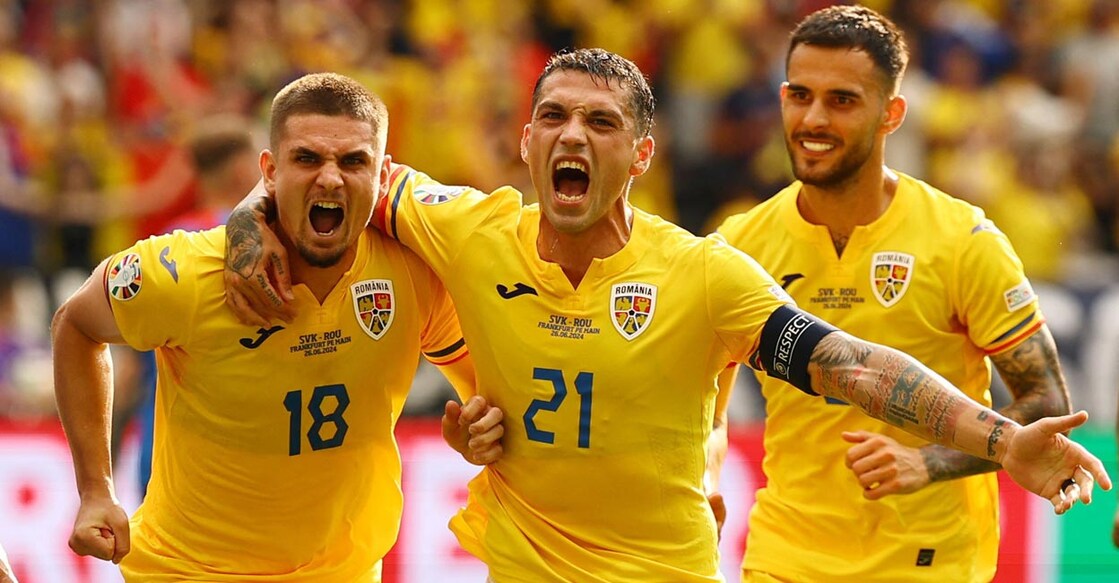 Romania's Razvan Marin, left, celebrates with teammates after scoring against Slovakia. Photo: Reuters/Kai Pfaffenbach