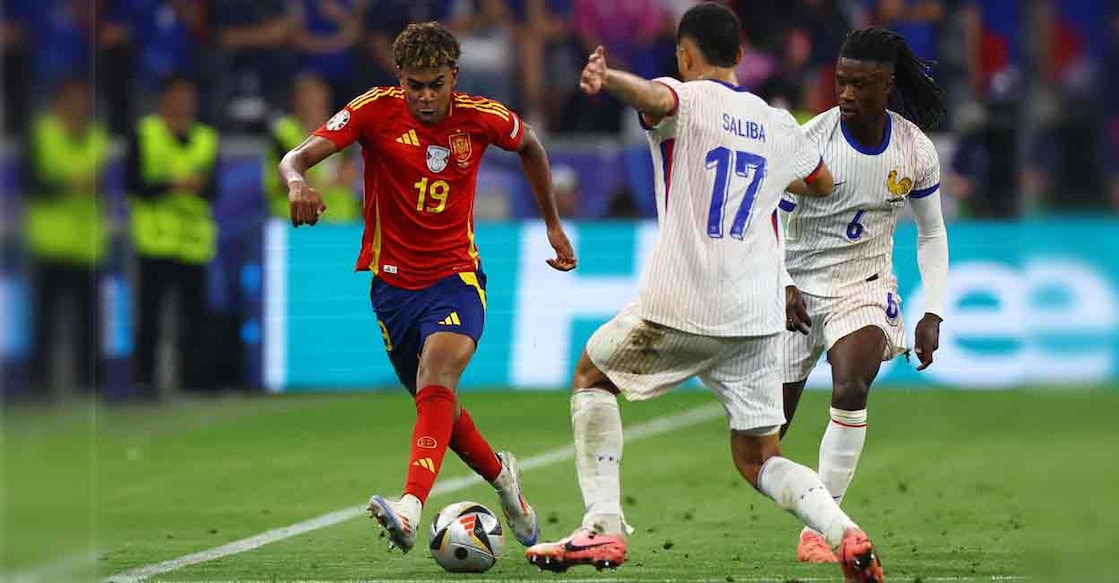 Spain's Lamine Yamal in action with France's William Saliba and Eduardo Camavinga. Photo: REUTERS/Leonhard Simon