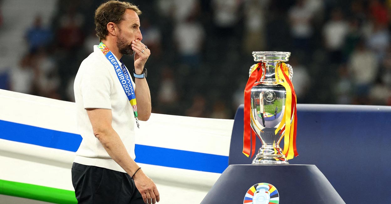 Gareth Southgate looks dejected as he walks past the Euro trophy after receiving his runners-up medal. File photo: Reuters/Kai Pfaffenbach
