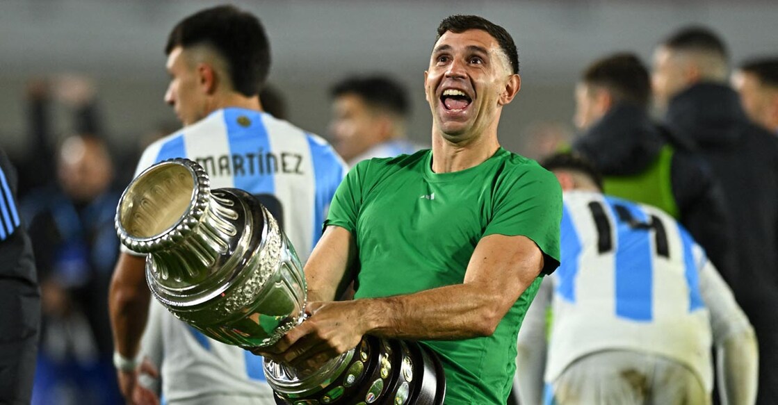 Emiliano Martinez celebrates with the Copa America's trophy after the World Cup qualifer against Chile. File photo: Reuters/Rodrigo Valle