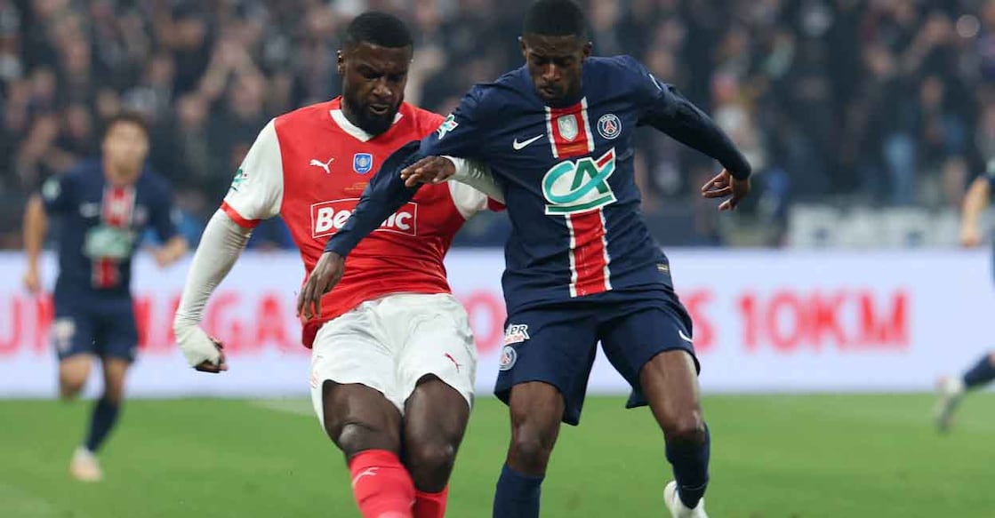 Soccer Football - Coupe de France - Final - Paris St Germain v Stade de Reims - Stade de France, Saint-Denis, France - May 24, 2025 Stade de Reims' Cedric Kipre in action with Paris St Germain's Ousmane Dembele REUTERS/Denis Balibouse