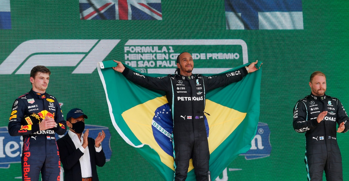 Lewis Hamilton celebrates on the podium. Photo: Reuters