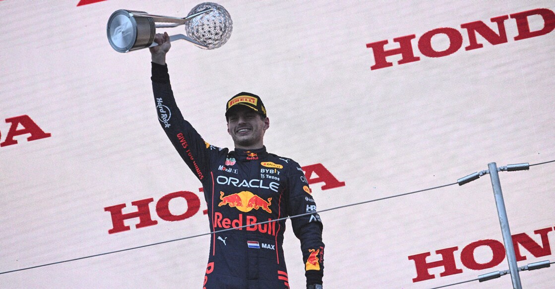 Max Verstappen poses on the podium with the trophy. Photo: AFP/Philip Fong