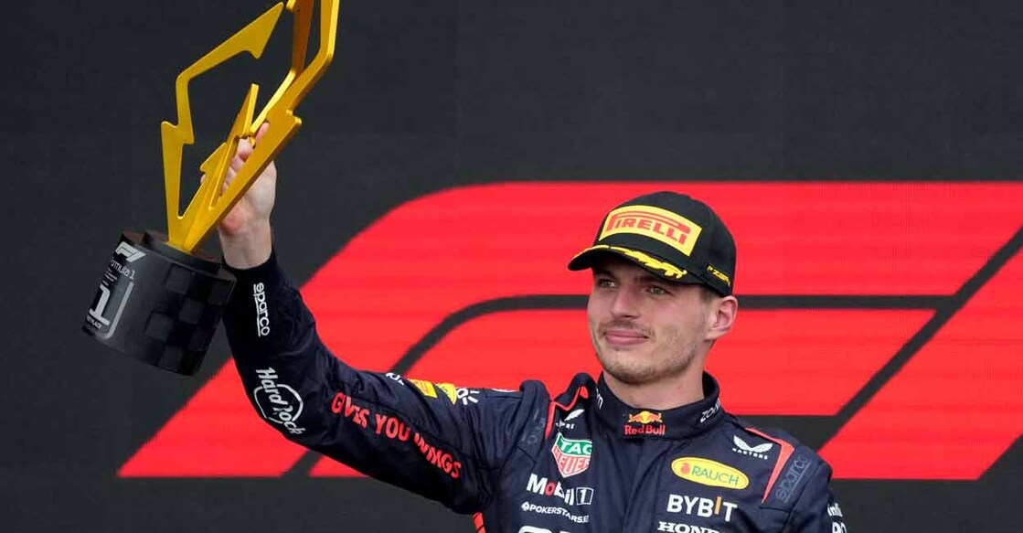 Red Bull's Max Verstappen celebrates with a trophy on the podium after winning the race. Photo: REUTERS/Mathieu Belanger