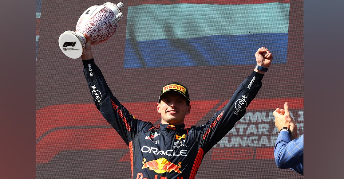 Red Bull's Max Verstappen celebrates on the podium with the trophy after winning the Hungarian Grand Prix. Photo: Reuters/Bernadett Szabo