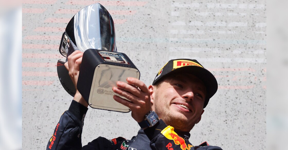 Red Bull's Max Verstappen celebrates with a trophy on the podium. Photo: Reuters/Johanna Geron