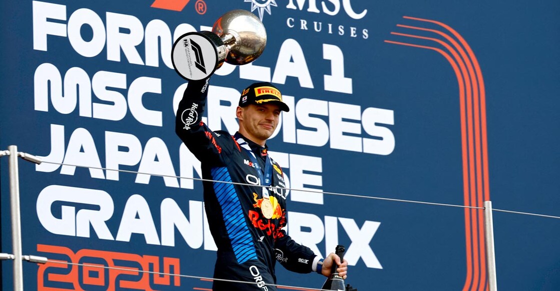 Red Bull's Max Verstappen celebrates with the trophy on the podium. Photo: Reuters/Issei Kato