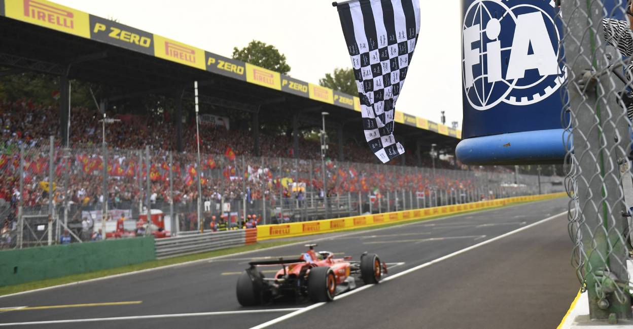 Ferrari's Charles Leclerc passes the chequered flag, waved by former footballer Alessandro Del Piero to win the Italian Grand Prix Massimo Pinca. Photo: Reuters